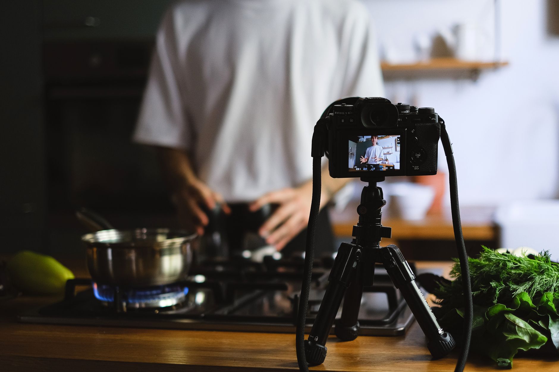 A camera recording a cooking tutorial in a kitchen