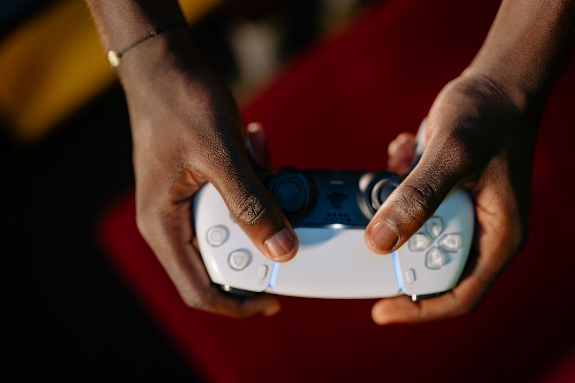 Close-up of hands gripping a wireless gaming controller